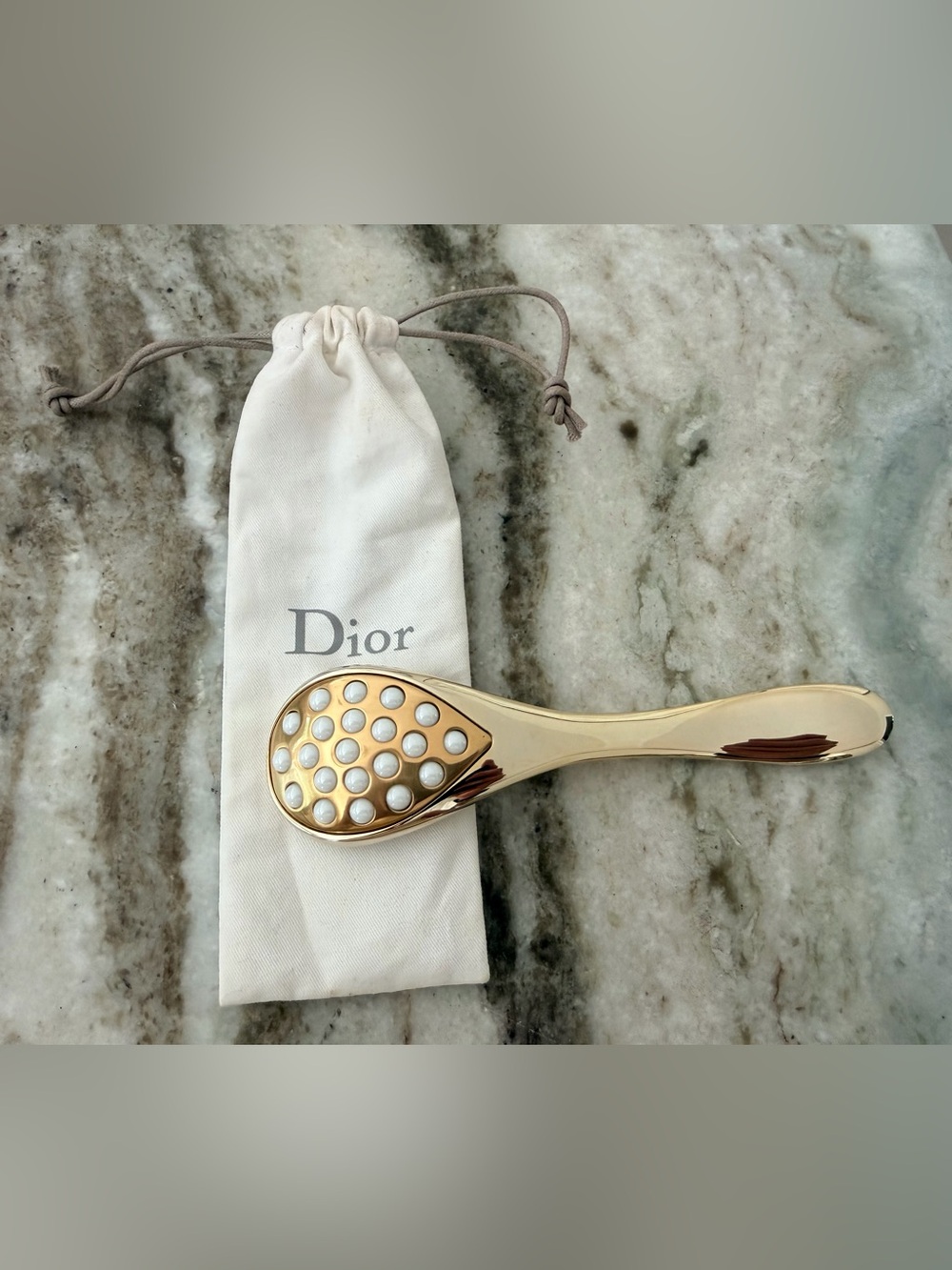 Dior Prestige Le Pétale Multi-Perlé Massage Tool with a branded protective pouch